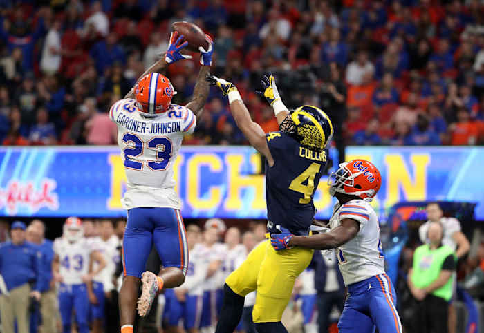 Florida Gators defensive back Chauncey Gardner-Johnson (23) intercepts a pass for Michigan Wolverines receiver Nico Collins (4). Mandatory Credit: Jason Getz-USA TODAY